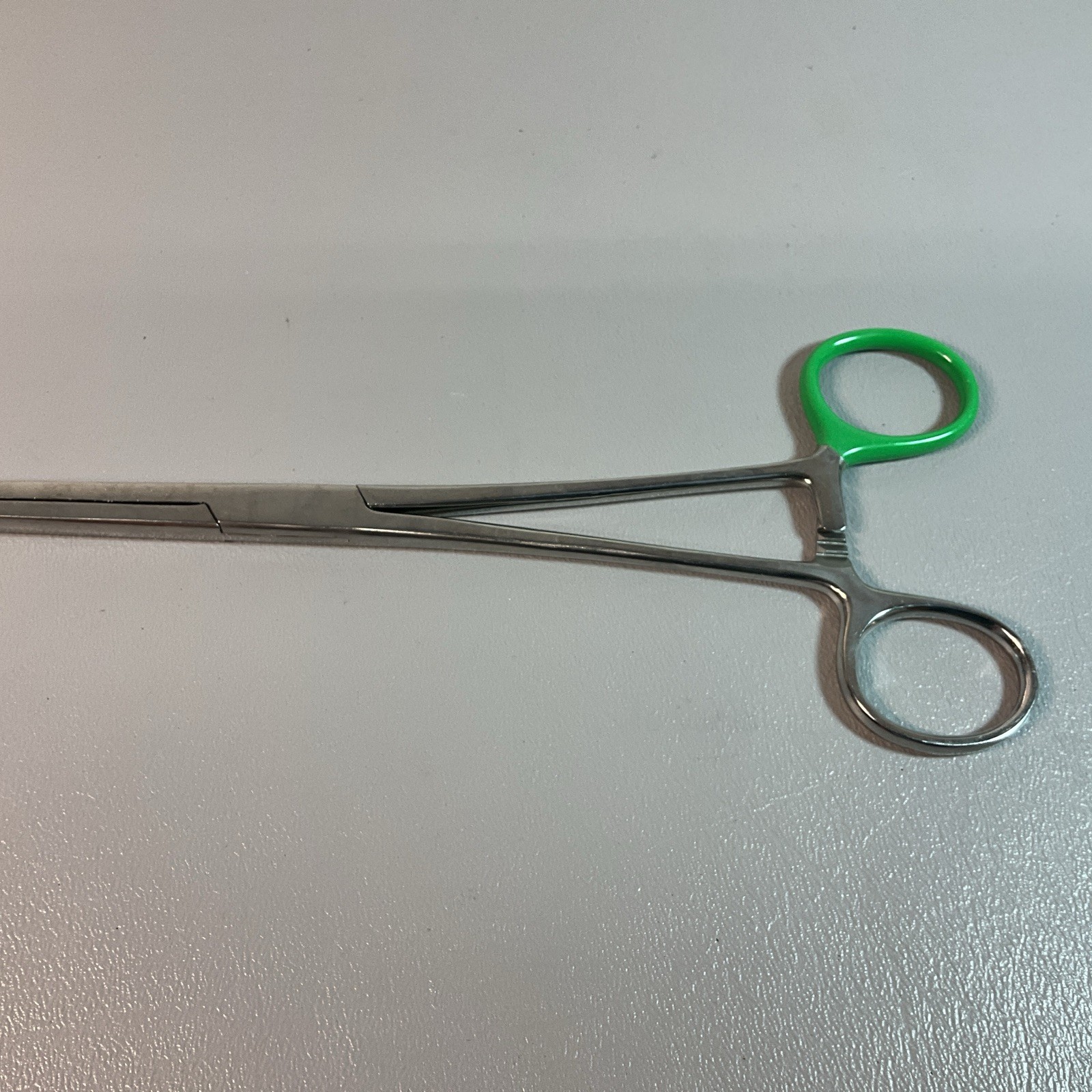 UNBRANDED SEVEN INCH FORCEPS, GREEN TAPE ON HANDLE, PAKISTAN. (C209)