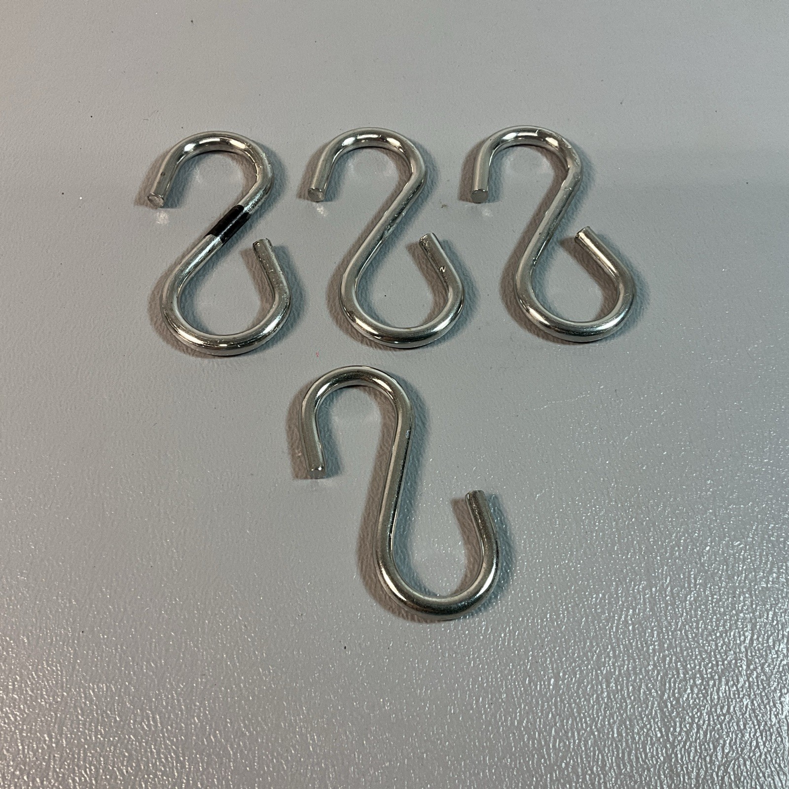 FOUR UNBRANDED HOOKS, TWO INCHES LONG. (C224)